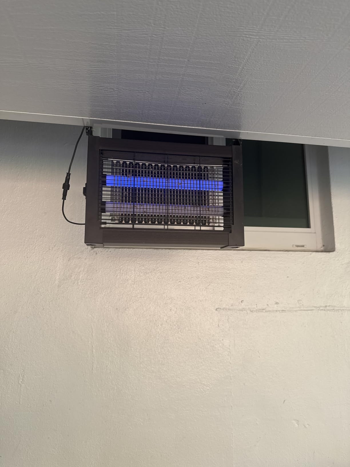 Zapper wall-mounted beside a patio door